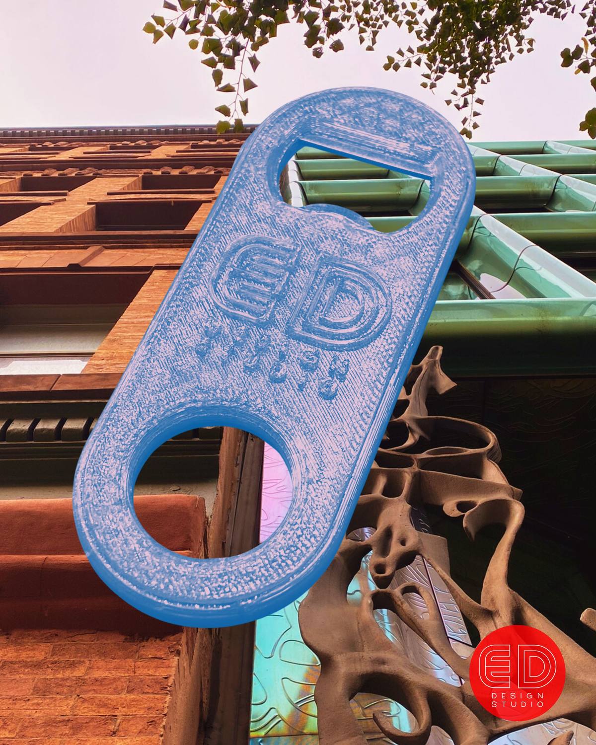 A translucent blue 3D-printed bottle opener with the ED Design Studio logo embossed on its face